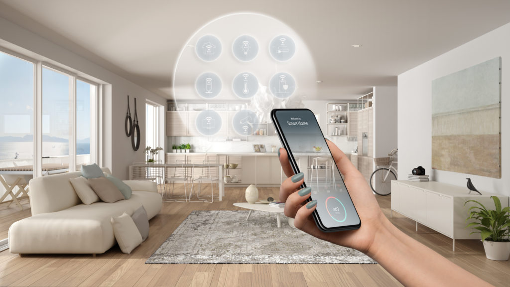 Smart home technology interface on phone app, augmented reality, internet of things, interior design of modern kitchen with connected objects, woman hand holding remote control device